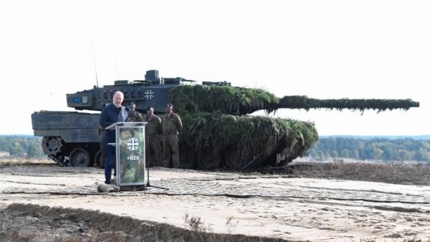 German Chancellor Olaf Scholz delivers a speech in front of a Leopard 2 tank during a visit to a military ba<em></em>se of the German army Bundeswehr in Bergen, Germany, October 17, 2022. 